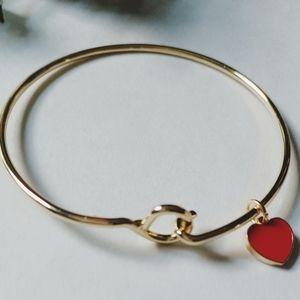 Gold tone charm bangle